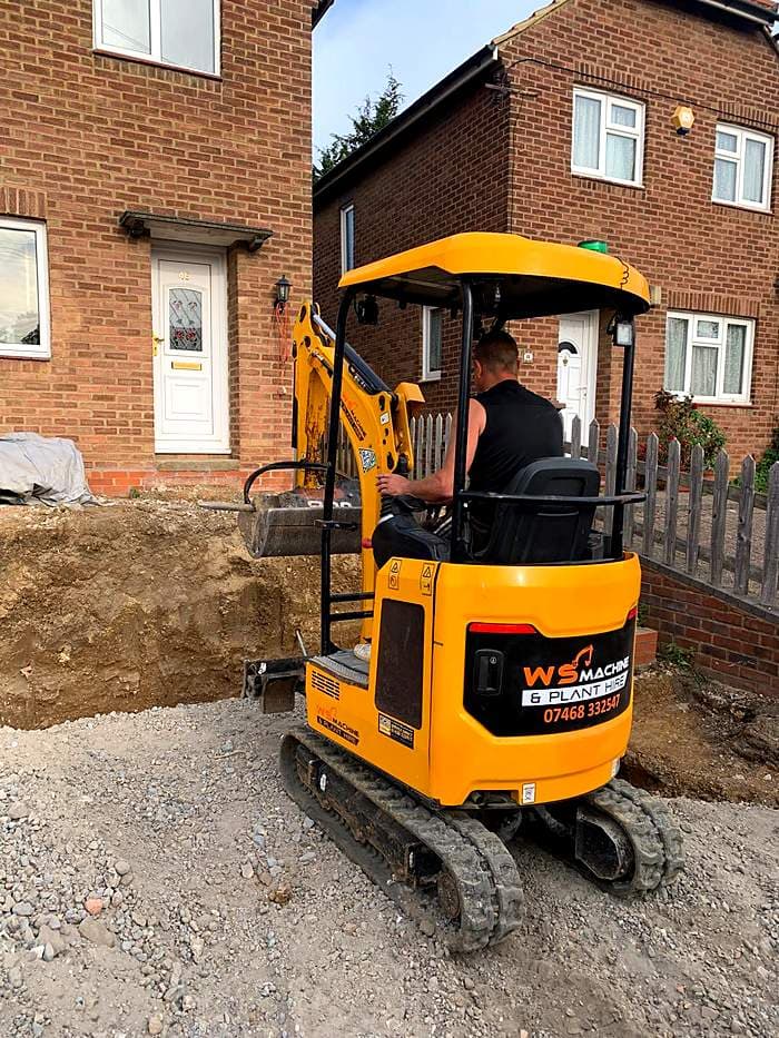 WS Machine operator digging a trench on a residential job